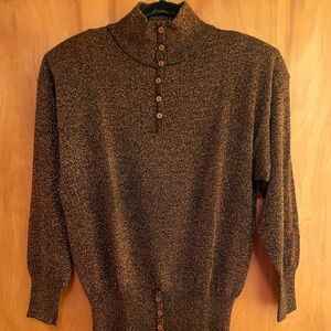 Woman’s copper metallic and black knit top.